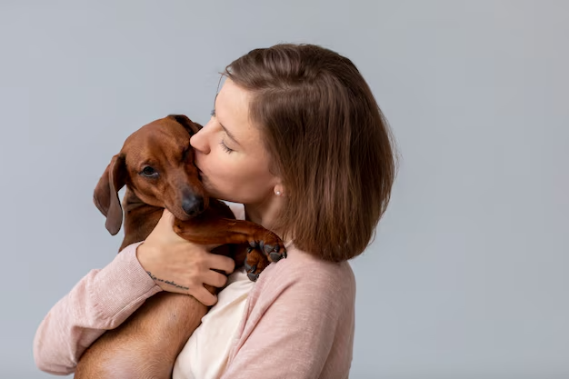 A woman tenderly embracing her dog